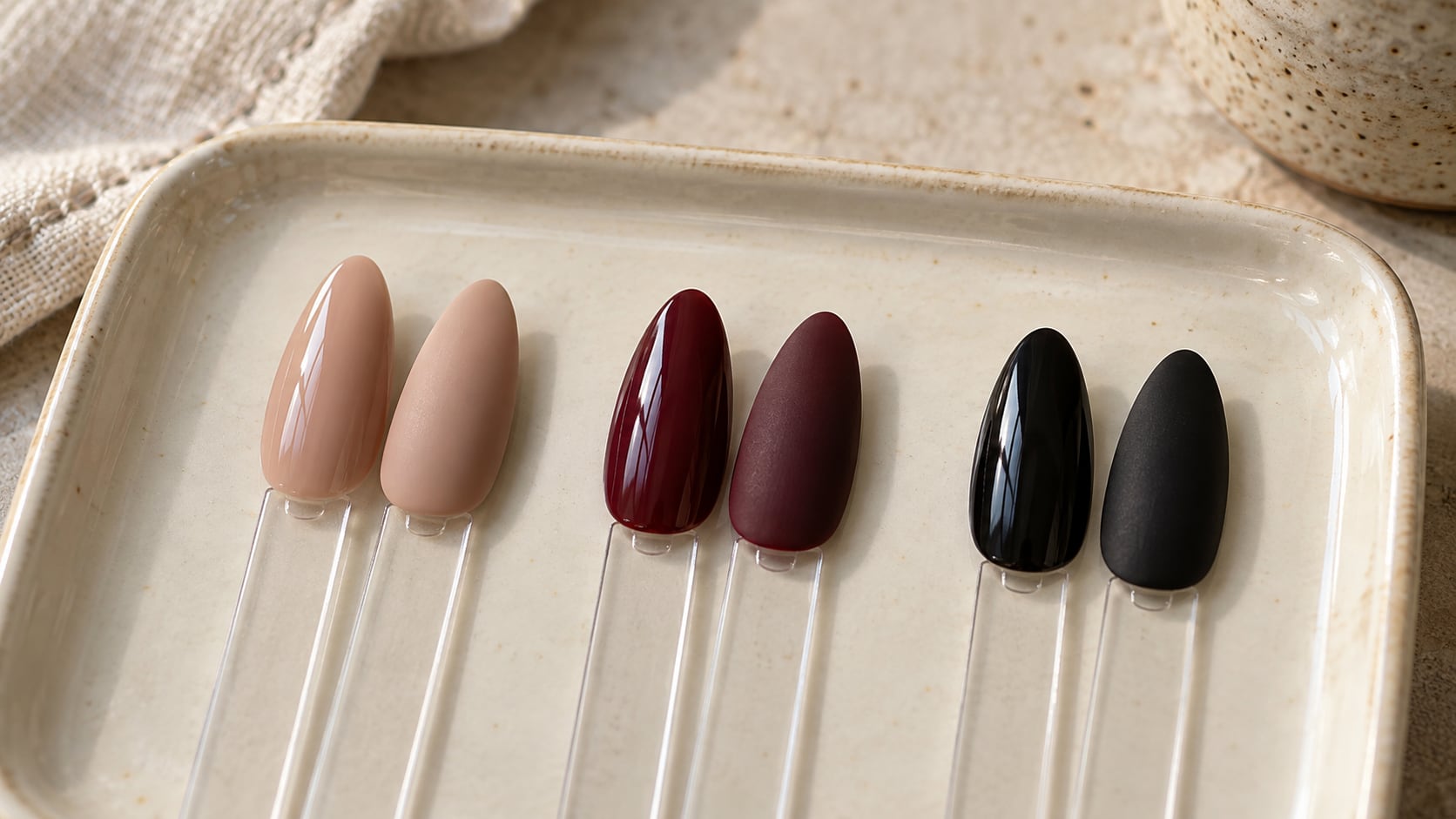 Pairs of nude, burgundy and black nail swatches comparing glossy and matte finishes